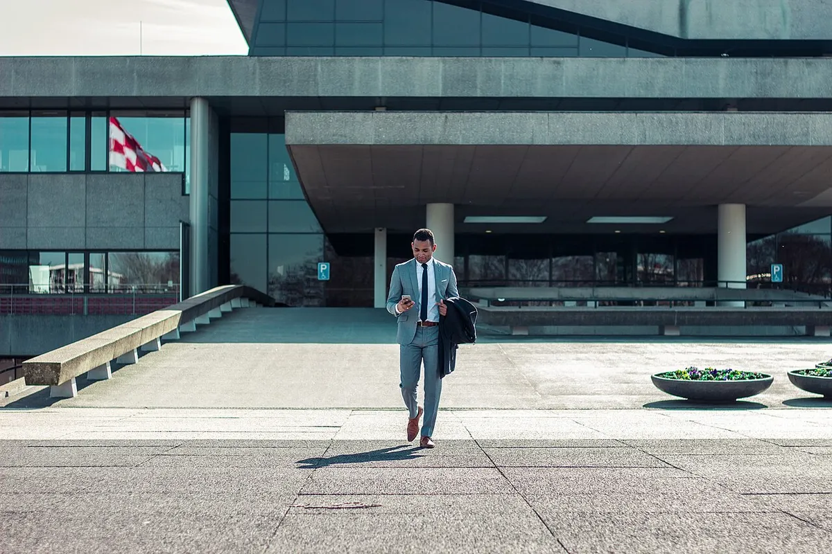 A businessman carrying his belongings as he leaves an office building